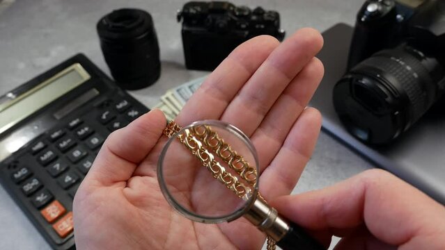 golden chain, digital camera and money, laptop, store selling photographic equipment, pawnshop, closeup