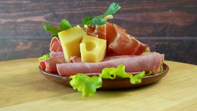 Cold Smoked Meat, jamon, sausage, cold meat, cheese. Plate, antipasto set platter wooden plate. Cold smoked meat plate with sliced ham, prosciutto, bacon