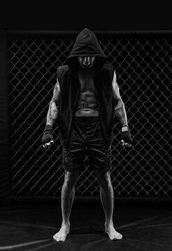 The dramatic black white image of the MMA fighter. Photography in a real octagon. Brutal fighter