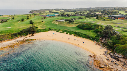 Naklejka premium Aerial view from a drone of Litlle Bay Beach, hidden between rocks and a golf course. Located in Australia, Sydney.