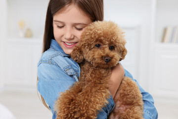 Little child with cute puppy at home. Lovely pet