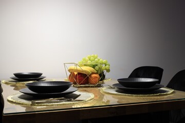 Table set for dinner near white wall