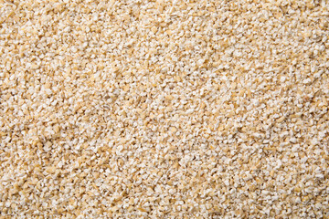 Raw barley groats as background, top view