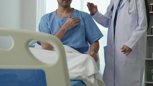 Doctor  listening lungs and test rise patient hand with chest pain and had a risk for heart attack in hospital.