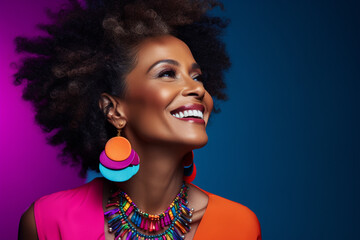 Mature young dark skin woman with black afro hair isolated in minimal background, happily smiling black woman wearing fancy jewelries and colorful cloths side face close up portrait, healthy skin care - obrazy, fototapety, plakaty