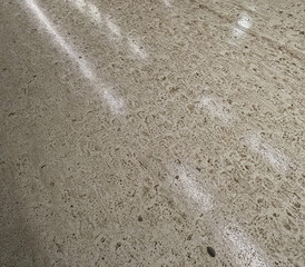 Wet floor with muddy footprints and light streaks in the winter