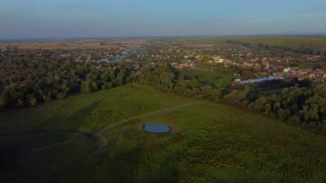 Beautiful nature ecosystem with small pond, lake with blue sky and forest and land in the distance in national park Obedska bara seen from aerial drone