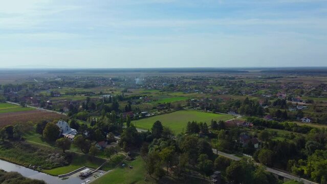 Beautiful nature ecosystem with small pond, lake with blue sky and forest and land in the distance in national park Obedska bara seen from aerial drone