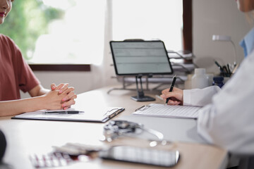 Asian psychologist women giving help and support to counseling about medicine and mental health therapy to patient in clinic while female patient stress and anxiety with psychological health problem