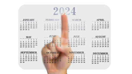 Man's hand pointing to a 2024 calendar.
