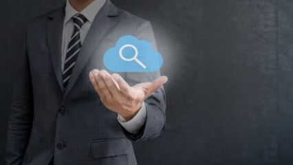 Businessman with an open hand holding a cloud search icon. Business concept.