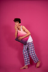 Retro style. A funny curly guy gets ready for his work day early in the morning. Pink background.