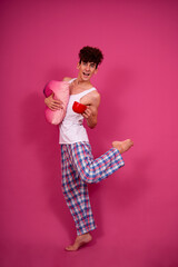 Retro style. A funny curly guy gets ready for his work day early in the morning. Pink background.