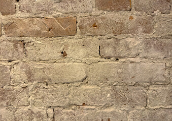Fragment of an old wall with cracks and holes. Structure of an old wall. Architectural concept for repair, restoration and construction.