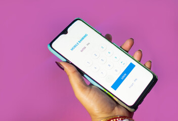 Female hands using mobile banking on a white smartphone.