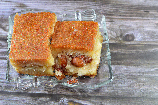 Egyptian Harissa, a variety of semolina cakes in the Middle East, so decadent and sweet stuffed and filled with nuts, almonds, raisins, a tall, dense and sweet semolina cake dessert, sweet Harrissa