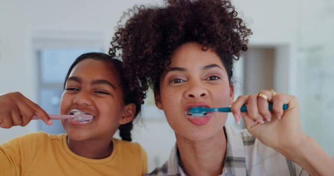 Mother, daughter and brushing teeth for dental hygiene, oral health and wellness, bathroom and support. Happy family, toothbrush and smile or laughing, clean and fresh breath or mouth, care and joy