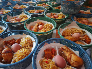 Nasi berkat, traditional food package from Indonesia. Meal given after religious recitation on Javanese tribe. Consist of rice, fried chicken, boiled egg, noodle, fried tempeh and sambal goreng.