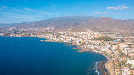 Fototapeta premium Aerial photo from drone to de Tenerife and beachs Adeje Playa de las Americas, Playa Honda,Playa de Troya, Playa de El Bobo.In the background Tenerife at sunset. Tenerife, Canary islands, Spain