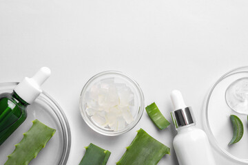 Flat lay composition with cosmetic products and cut aloe vera on white background. Space for text