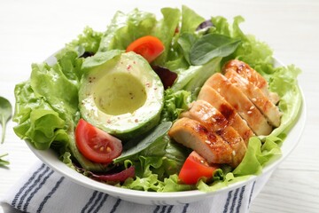 Delicious salad with chicken, cherry tomato and avocado on white table, closeup