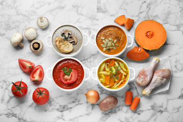 Tasty broth, different cream soups in bowls and ingredients on white marble table, flat lay