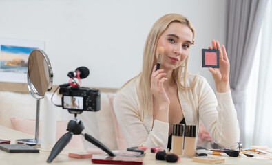 Young woman making beauty and cosmetic tutorial video content for social media. Beauty blogger...