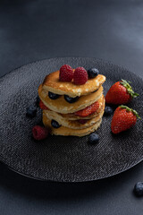 Pancakes with berries and honey, close-up