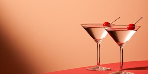Minimal scene of two martini glasses with red berries inside