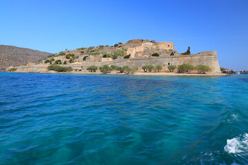 Fototapeta na wymiar Spinalonga Island on a Beautiful sunny day showing the turqoius sea and blue sky. Crete, Greece, Europe.