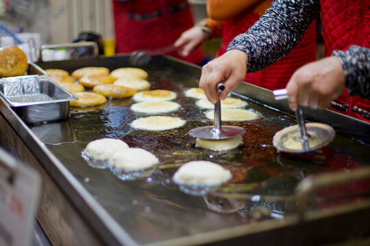 Woman Making Hotteok at Traditional Korean Market