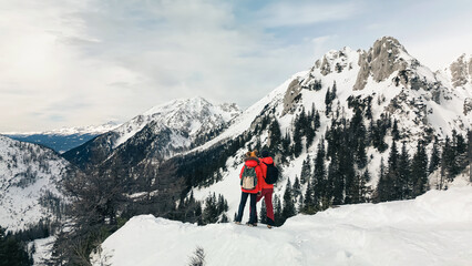 Naklejka na ściany i meble Happy couple enjoys a relaxing day outdoors in a stunning snowy landscape