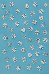 Decorative snowflakes  on blue background. White winter wooden decoration snow flakes.