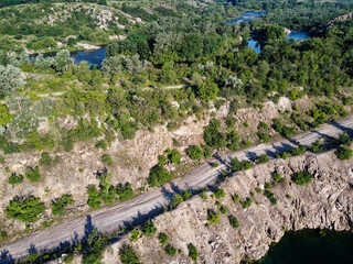 Rocky terrain overgrown with sparse vegetation, aerial view. Summer landscape from a bird's eye...