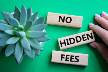 No Hidden Fees symbol. Concept words No Hidden Fees on wooden blocks. Businessman hand. Beautiful...