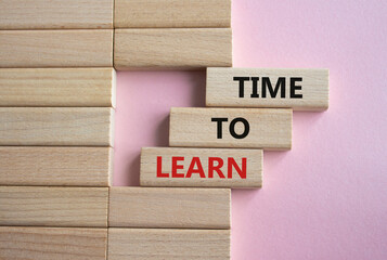 Time to learn symbol. Wooden blocks with words Time to learn. Beautiful pink background. Business...