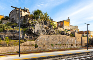 Volcanic rocks mixing with town architecture in Bronte over Simeto river valley on western slope of Mount Etna volcano in Catania region in Sicily, Italy