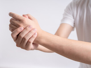 Young asian man suffer from wrist pain and pressing hand to sore spot, isolated on white background. Distension trauma, luxation and chronic arthritis, carpal tunnel syndrome and sport injury