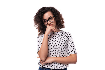 young successful caucasian businesswoman with curly hair is wearing a polka dot print blouse