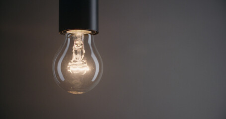 A classic incandescent light bulb burning and scattering light.