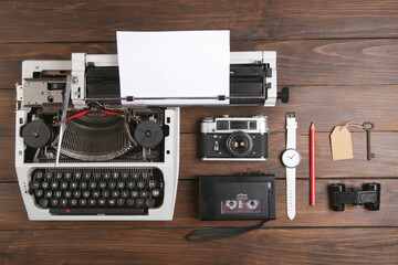 Journalist or private detective workplace - typewriter, camera, hat, recorder and other stuff, flat view above
