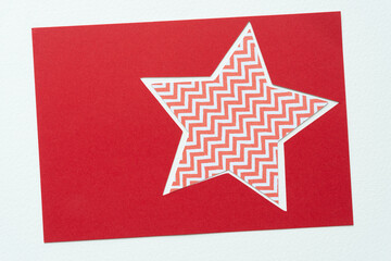 zigzag star inside a red star frame on white