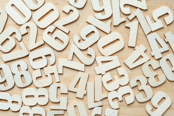 scattered wooden numbers on a wooden surface