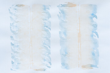 Obraz premium light blue and pastel orange gradient stains on blank paper