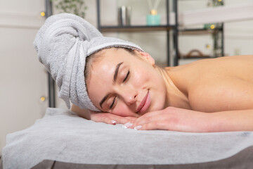Fototapeta na wymiar Young woman receiving back massage at spa salon. Beauty treatment concept.