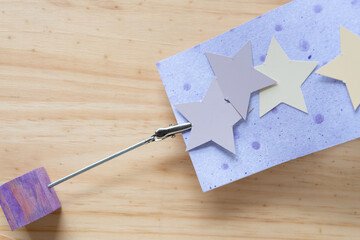 card holder, stars, and purple scrapbook paper on wood