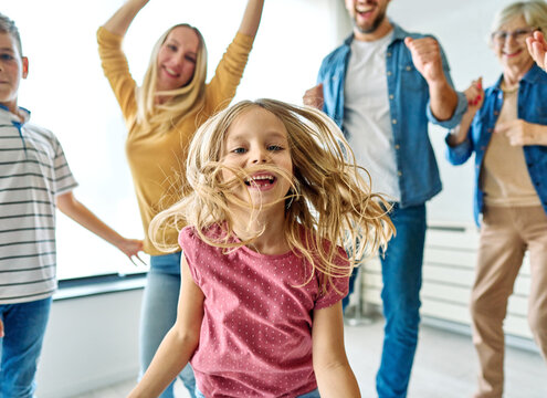 child family woman mother man father grandmother dancing music daughter group happy girl grandparent generation  grandchild together senior grandfather