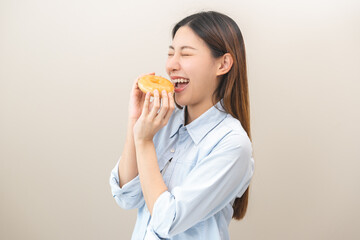 Portrait of pretty asian young woman holding dessert, donut glazed sugar, cute girl expression face...