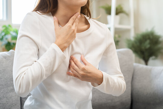 Acid reflux disease, suffer asian young woman have symptom gastroesophageal, esophageal, stomach ache and heartburn pain hand on chest from digestion problem after eat food, Healthcare medical concept
