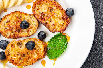 sweet breakfast French toast berrie, banana pancake fresh cooking meal food snack on the table copy space food background rustic top view